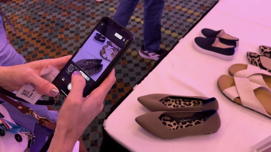 A seller photographing a shoe with Smart List AI