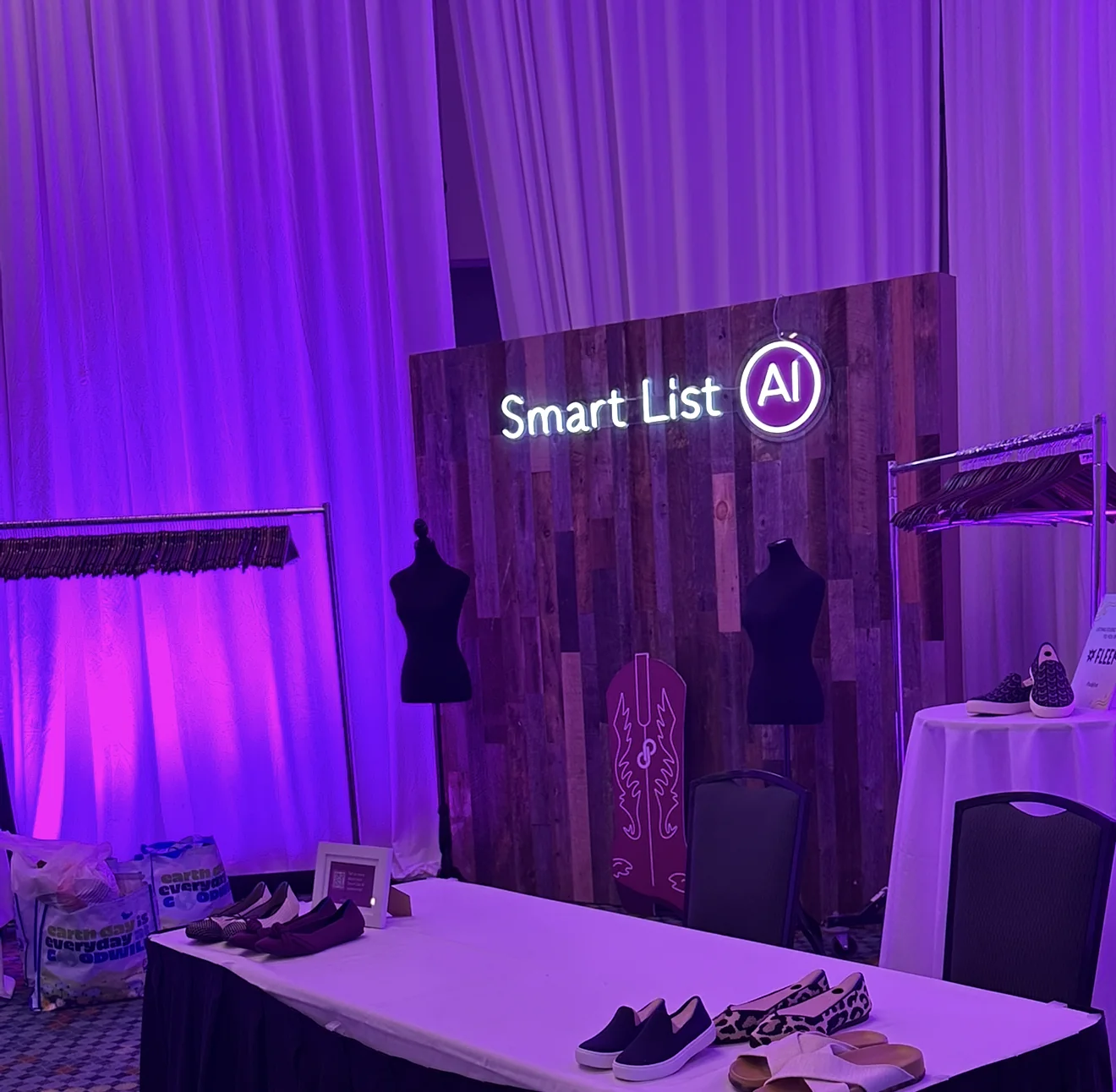 The Smart List AI booth at PoshFest Nashville 2024 — neon sign over a table of shoes